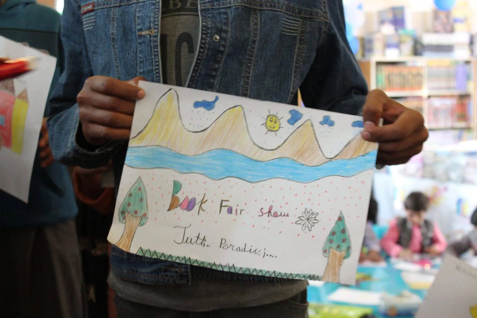 A painting exhibit by a fair goer